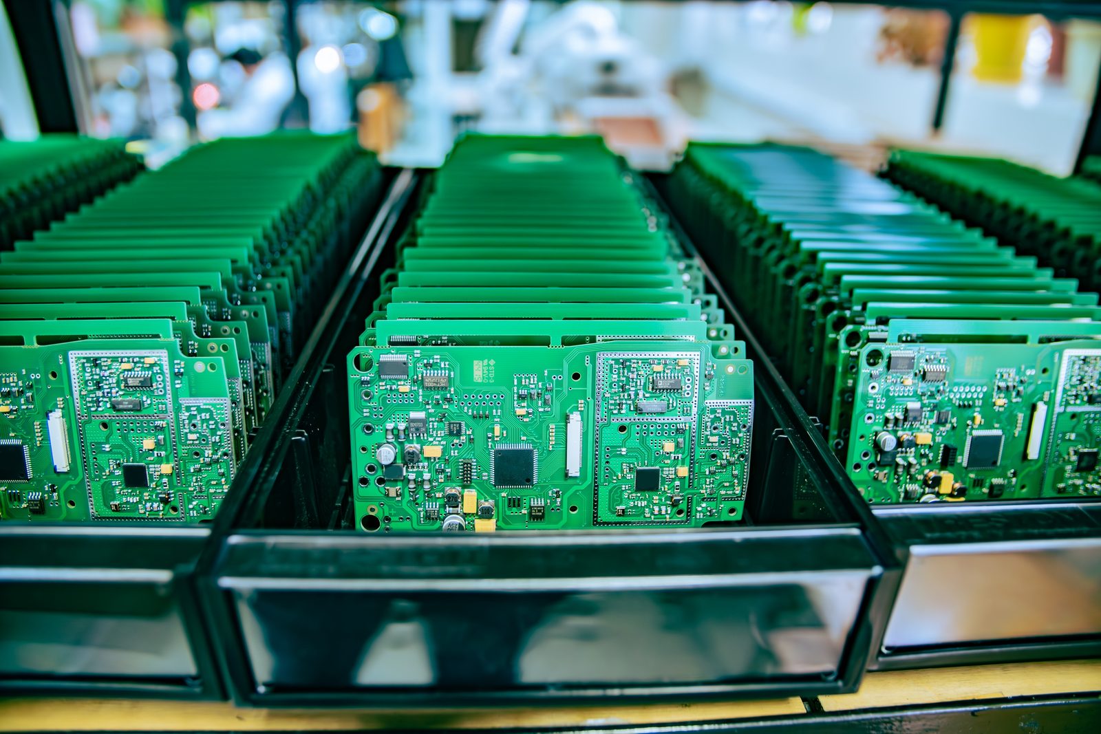 Completed printed circuit boards in production trays