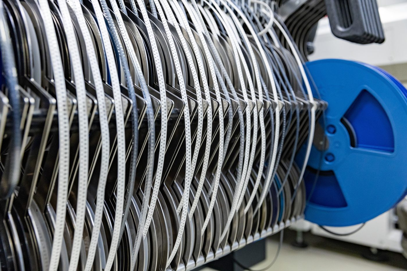 Component reels loaded into electronics manufacturing equipment